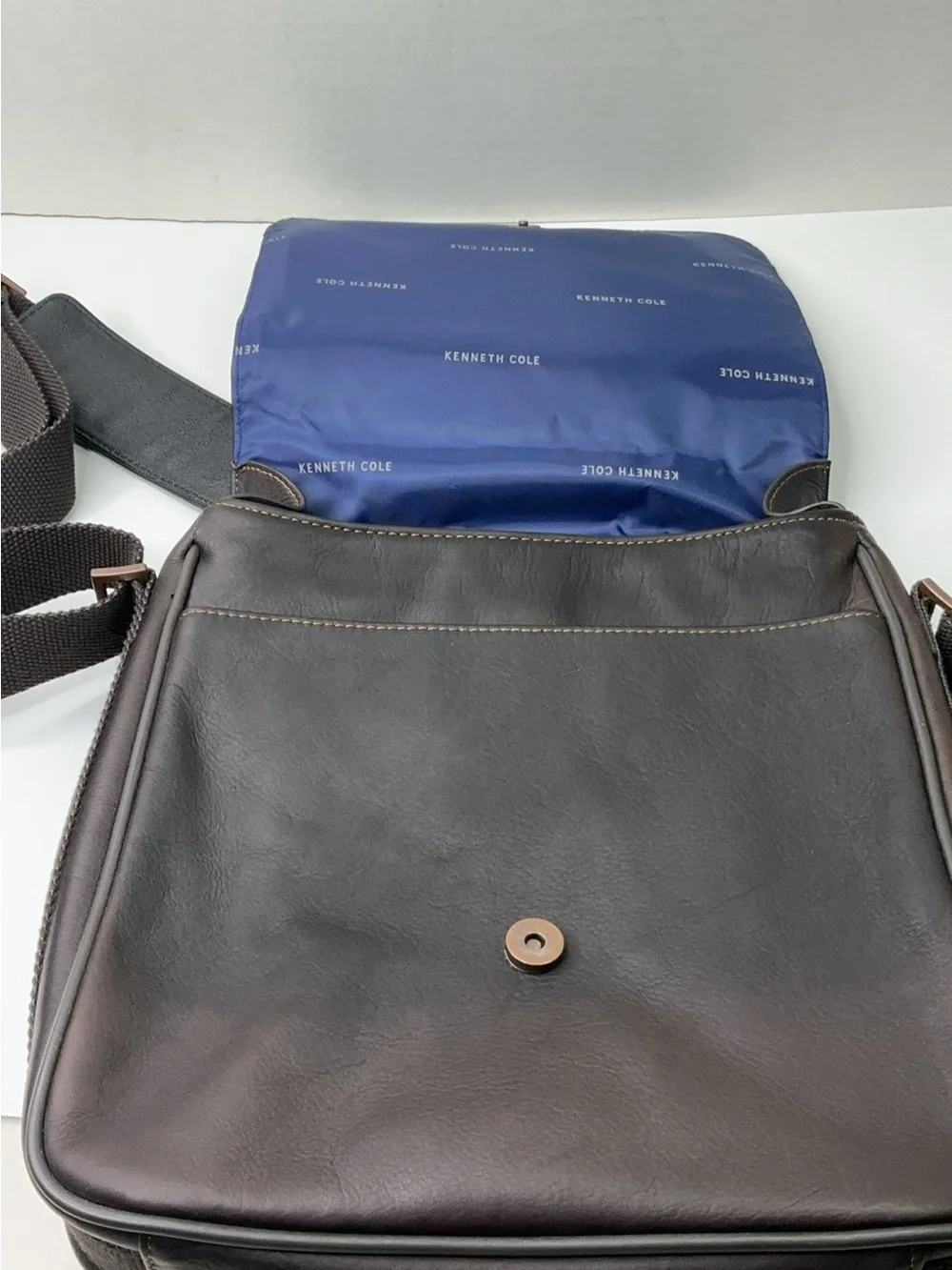 Kenneth Cole Reaction dark brown leather messenger-style tablet bag.